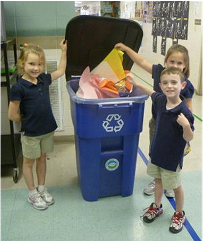 Three children recycling construction paper