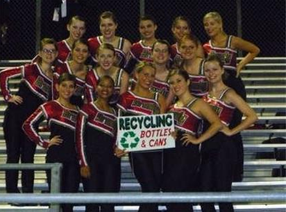 Dance team pose with Recycle Cans and Bottles sign