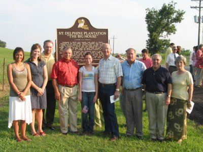 Group standing in front of the marker