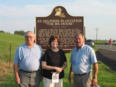 People standing in front of the historical marker
